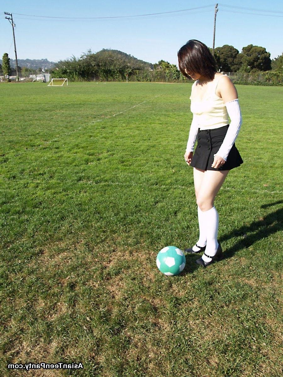 16P Asian teen playing soccer