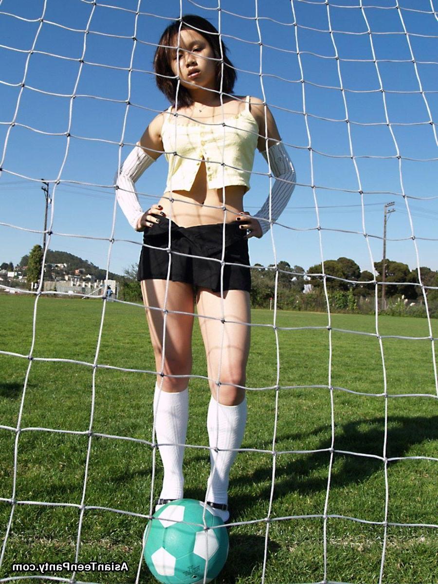 16P Asian teen playing soccer