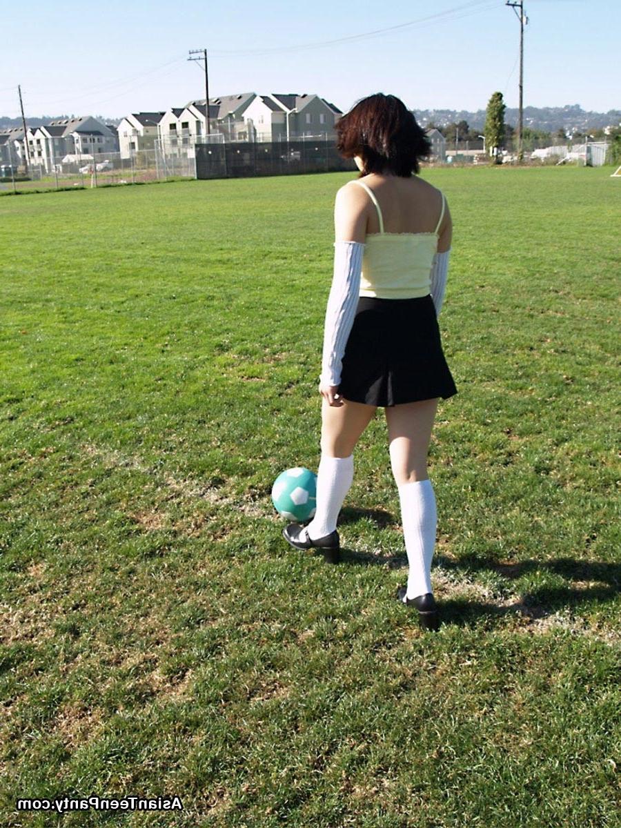 16P Asian teen playing soccer