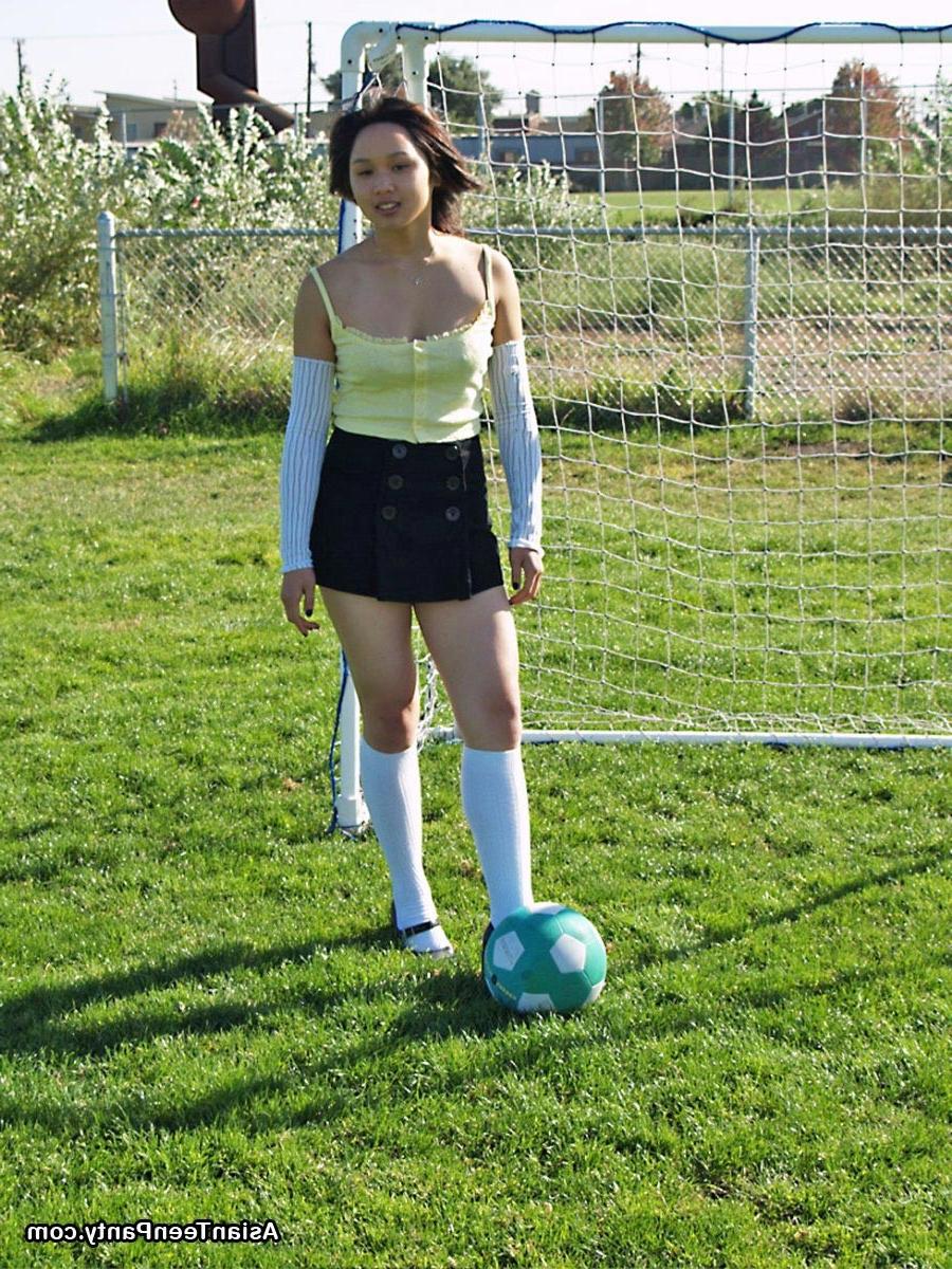 16P Asian teen playing soccer