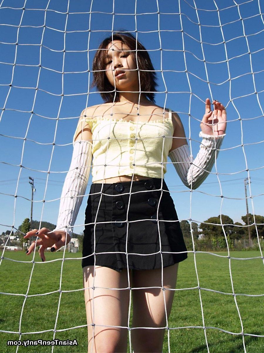 16P Asian teen playing soccer