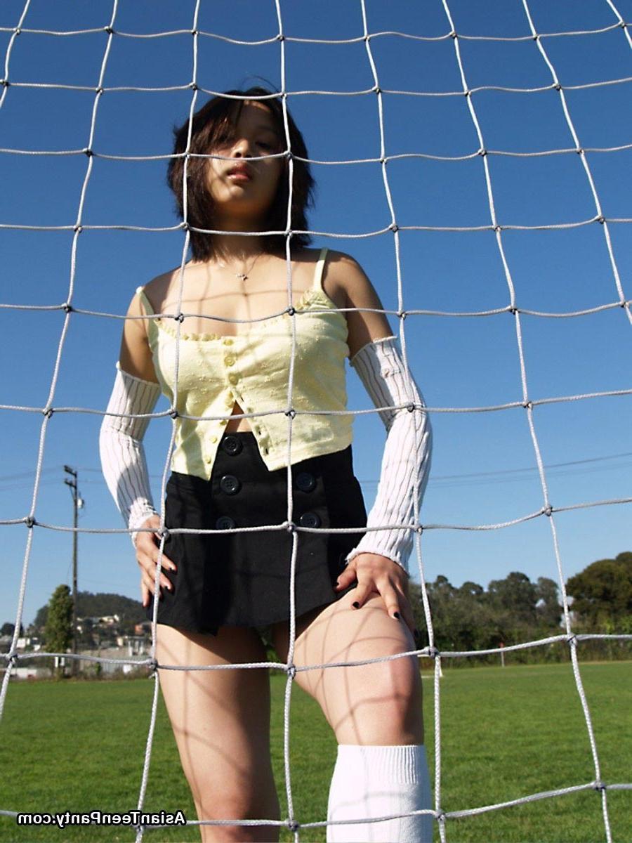 16P Asian teen playing soccer