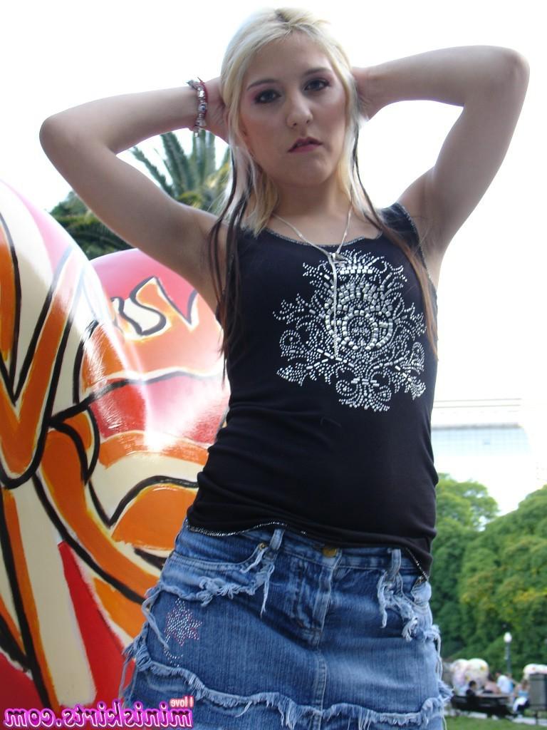 11P Blonde in black boots and tight blue jeans mini skirt posing outdoors