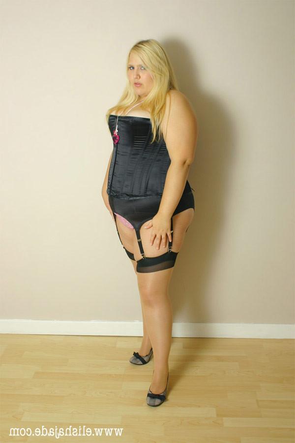 15P Seductive blonde plumper in seamed stockings and corset teasing