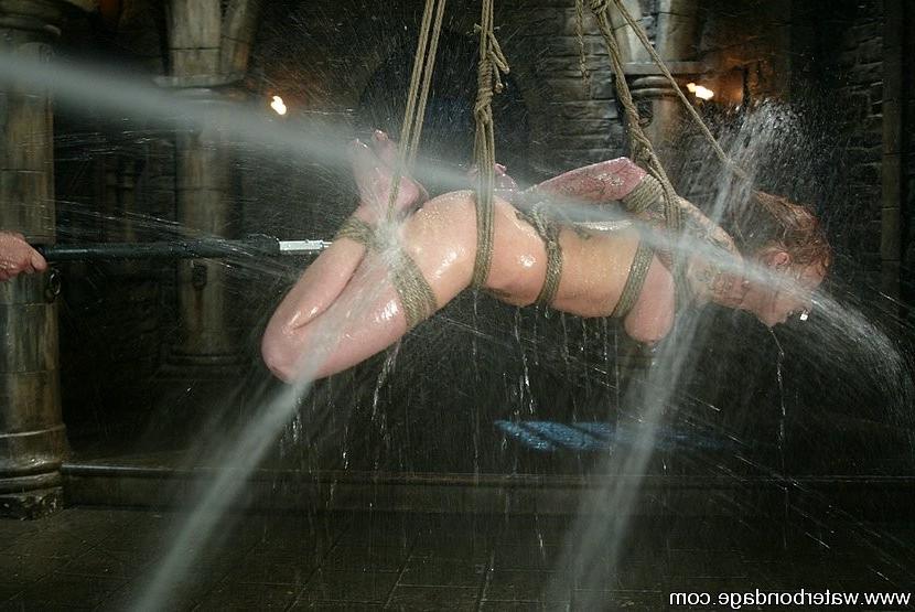 15P Scarlett Pain sexy redhead is tied up and sprayed with water