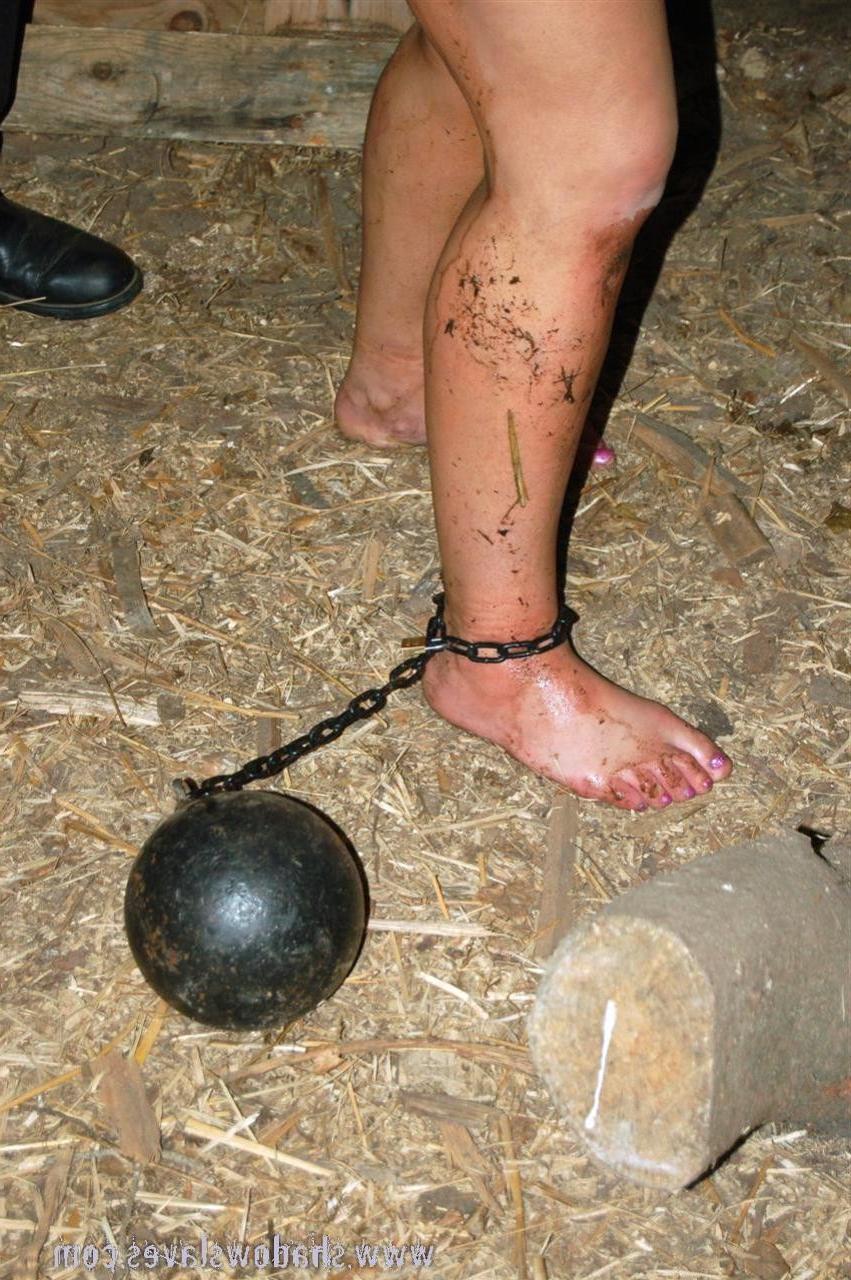 15P Blonde slave girl in chains is forced to chop wood