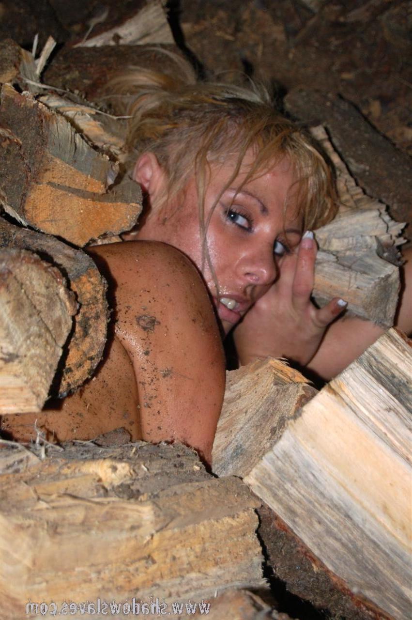 15P Blonde slave girl in chains is forced to chop wood