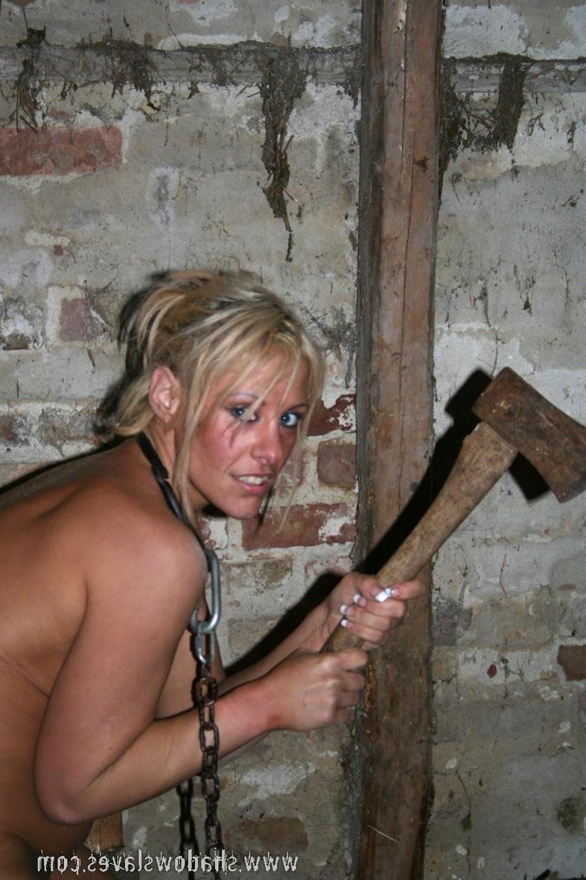 15P Blonde slave girl in chains is forced to chop wood