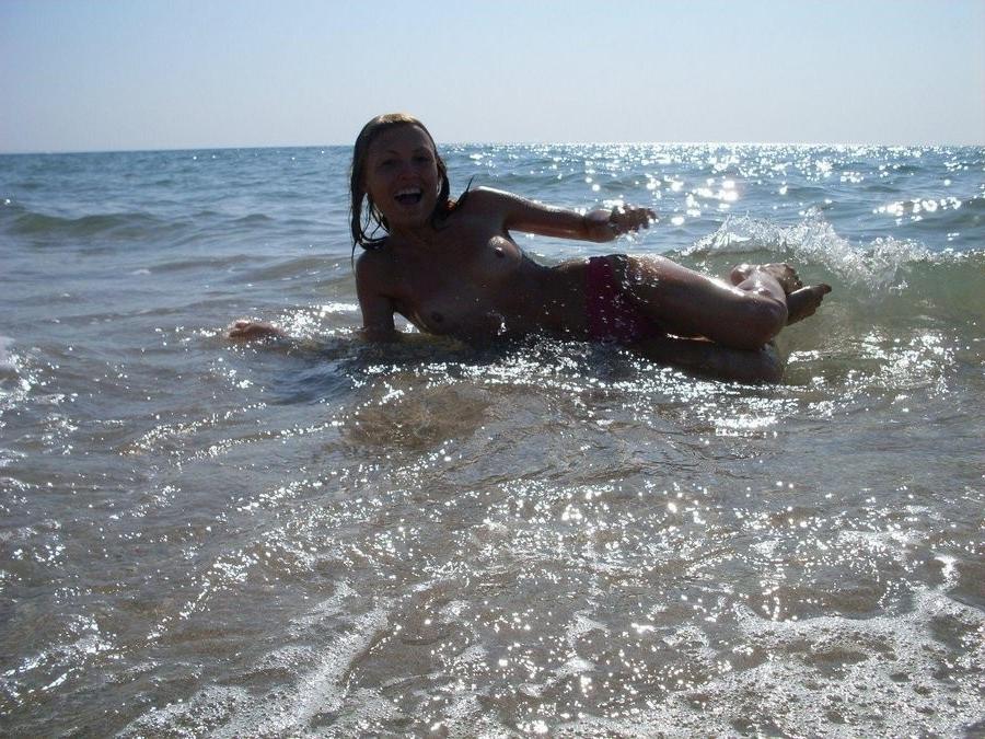 15P Her sexy body gets a tan after she strips naked