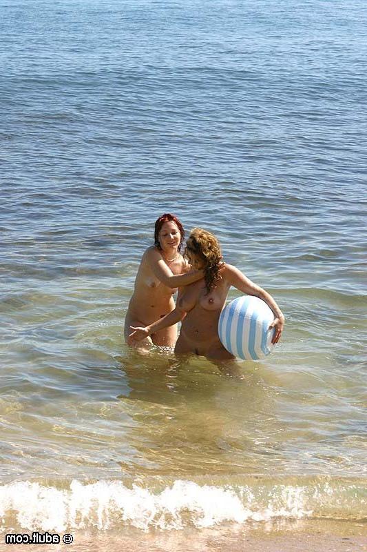 16P Beautiful nudist lesbians having a foursome on a sunny beach