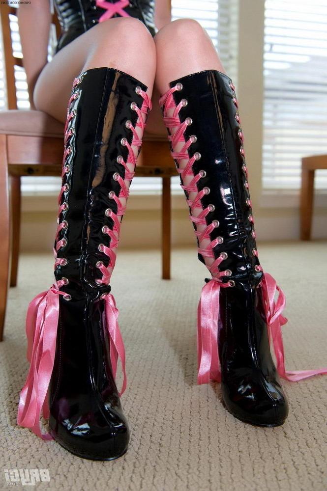 15P Bryci posing in a pink and black corset