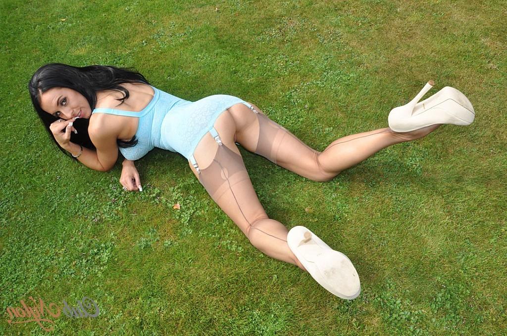 15P Busty brunette Lou Jenson shows off her sexy blue dress
