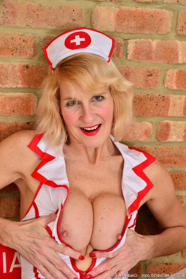 15P Molly Maracas busty milf nurse poses in white stockings