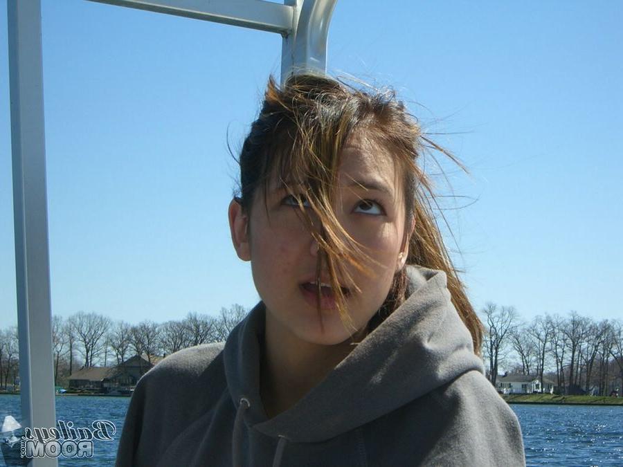 15P Bailey is a cute brunette with hard nipples posing on a boat