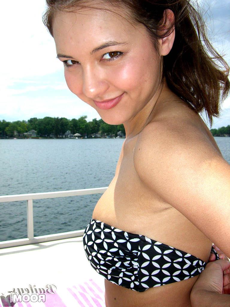 15P Busty teen cutie has fun tanning topless on a boat