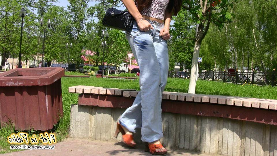 16P Bigtitted and longhaired amateur wets her blue jeans in a public park