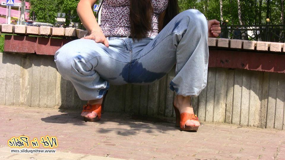 16P Bigtitted and longhaired amateur wets her blue jeans in a public park