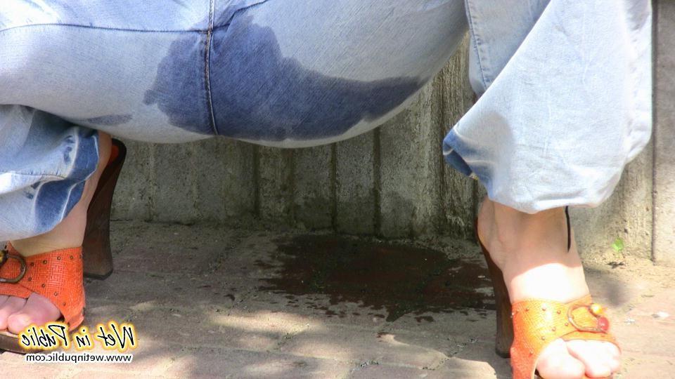 16P Bigtitted and longhaired amateur wets her blue jeans in a public park