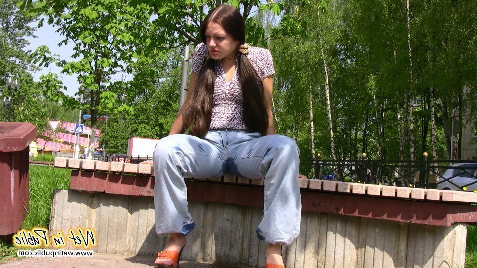 16P Bigtitted and longhaired amateur wets her blue jeans in a public park