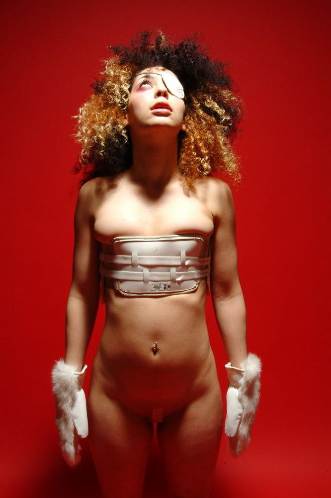 15P Gimp girl Kinky Zee posing in a back brace and eye patch