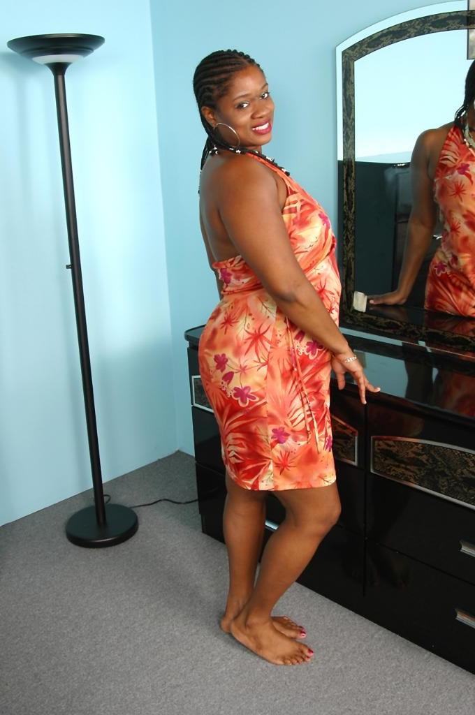20P Busty ebony milf loves strip teasing in a red dress