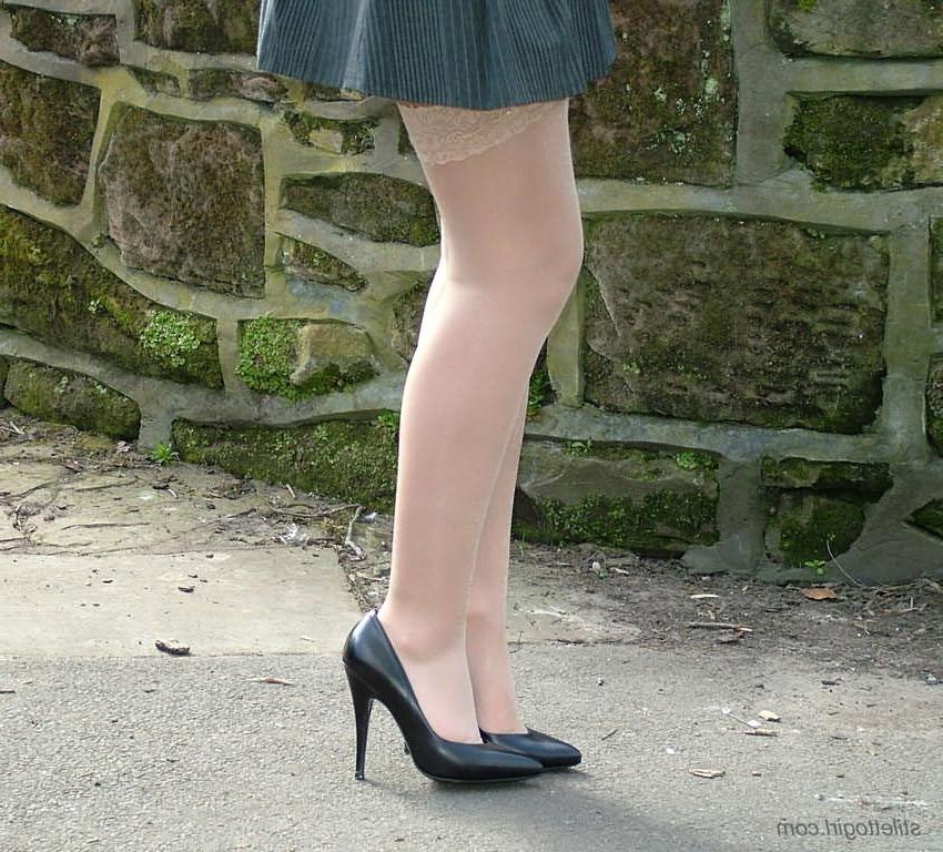 15P Shy blonde babe in stockings and heels outdoors