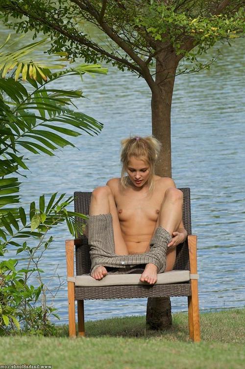 17P Stunning small titted blonde showing sensual striptease outdoors