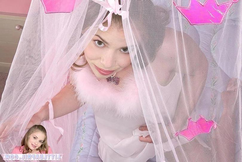 15P Barely legal honey poses in pink lingerie