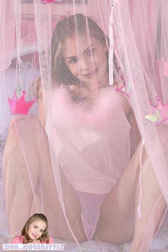 15P Barely legal honey poses in pink lingerie