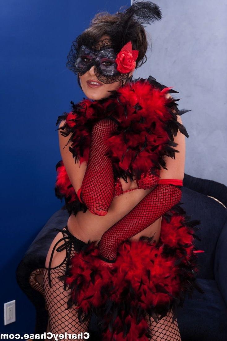 12P Charley Chase wears a red corset and stockings.