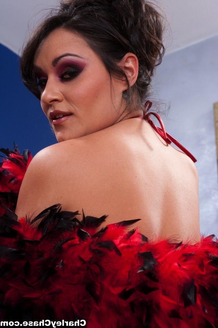 12P Charley Chase wears a red corset and stockings.