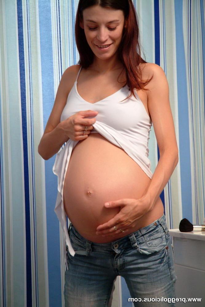 16P Slim pregnant beauty takes off her tight blue jeans