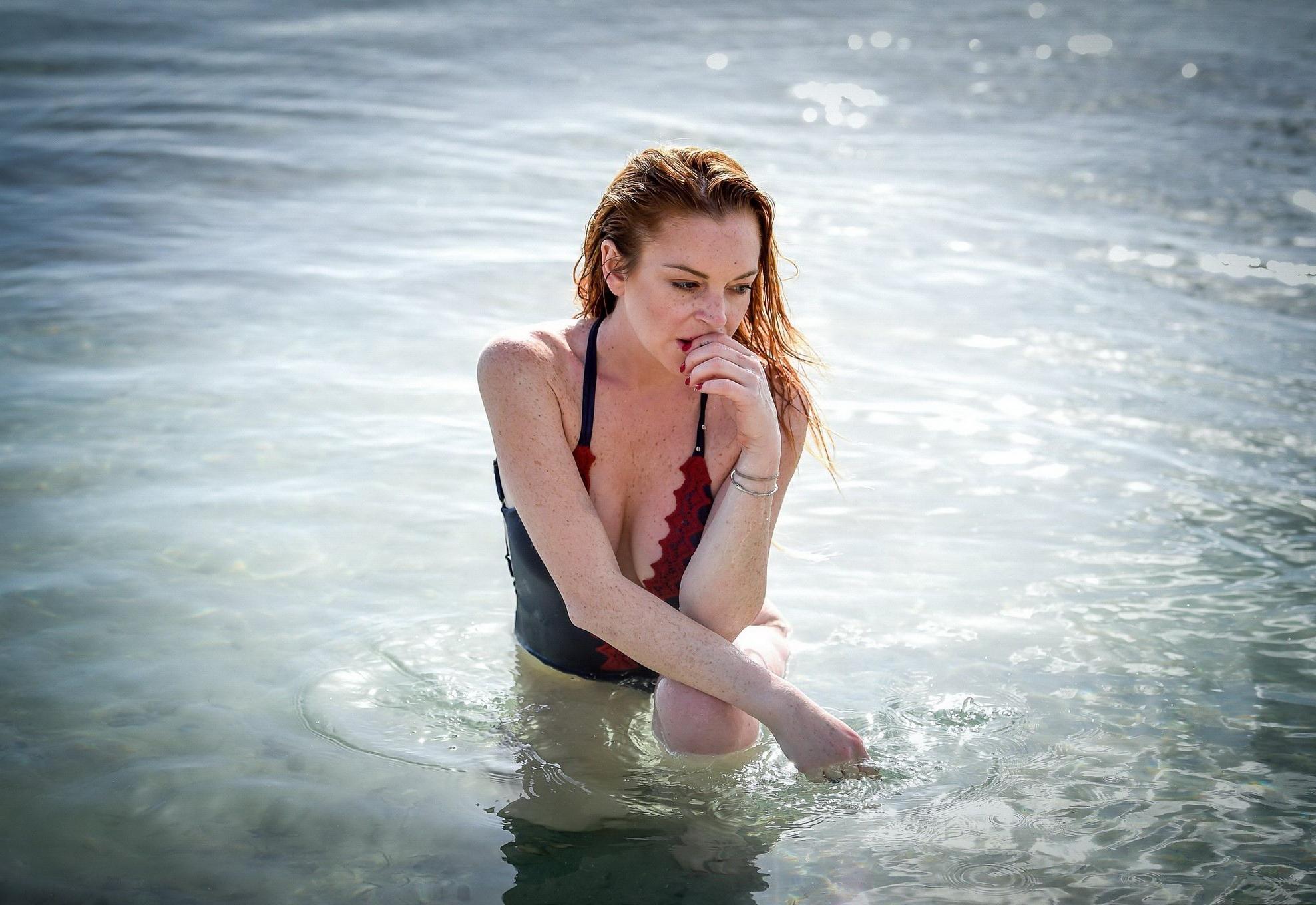 16P Lindsay Lohan busty in a blue plunging swimsuit