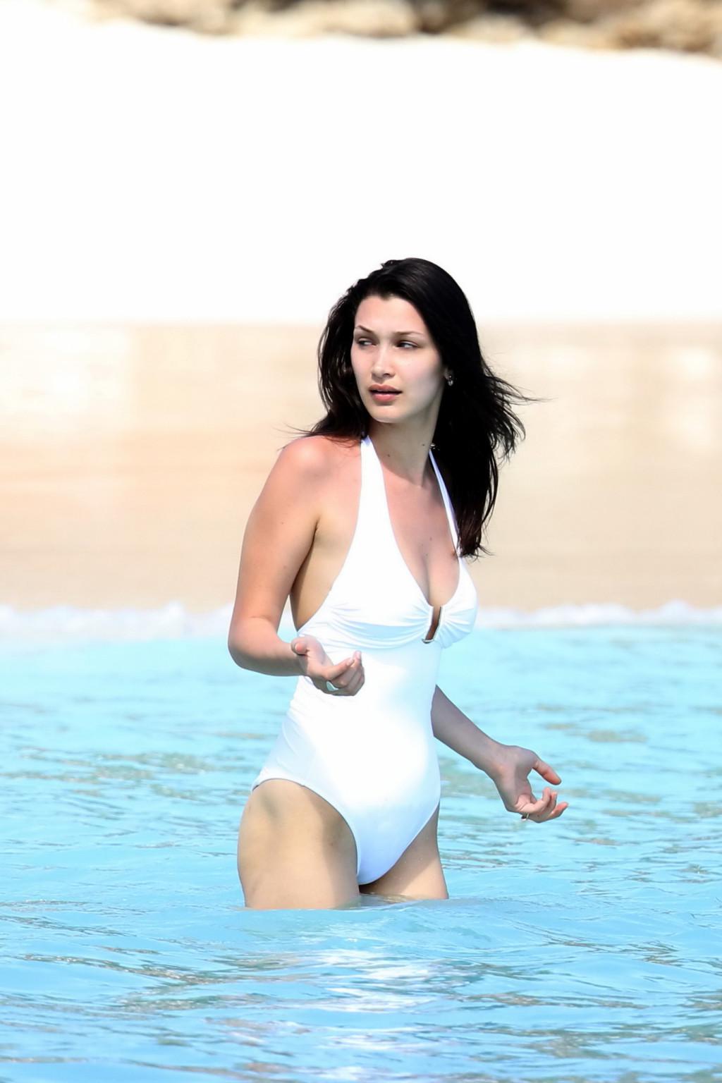 16P Bella Hadid busty and showing ass in white swimsuit