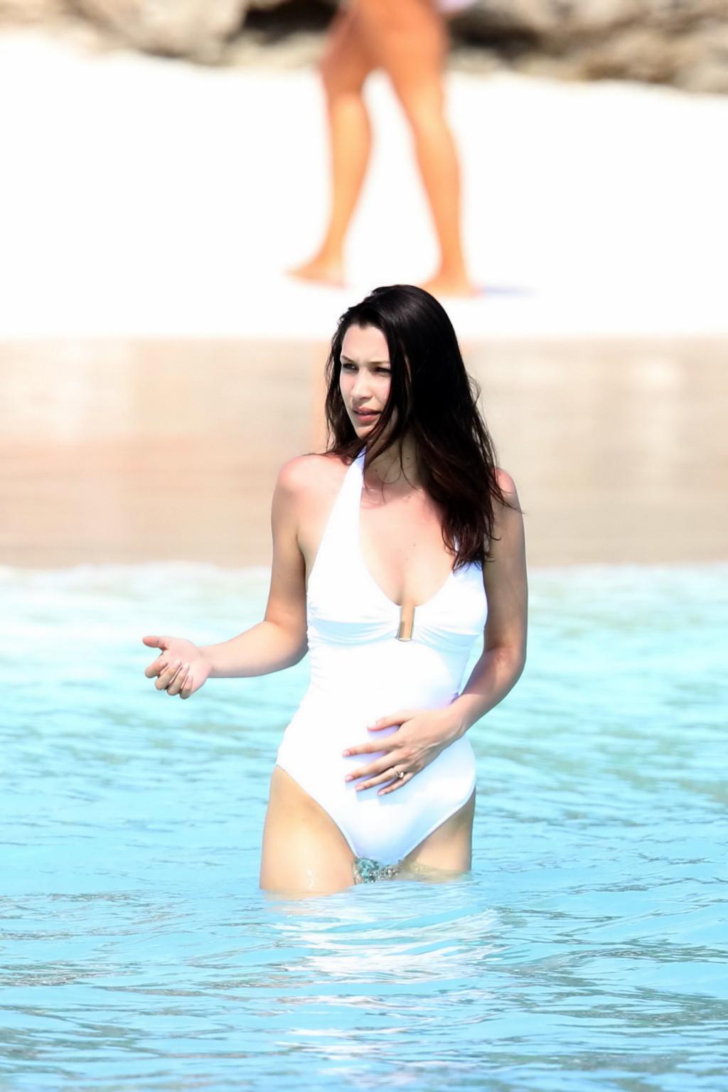 16P Bella Hadid busty and showing ass in white swimsuit