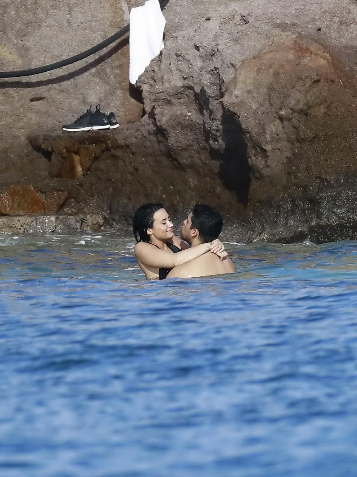 16P Demi Lovato showing her round ass in black swimsuit
