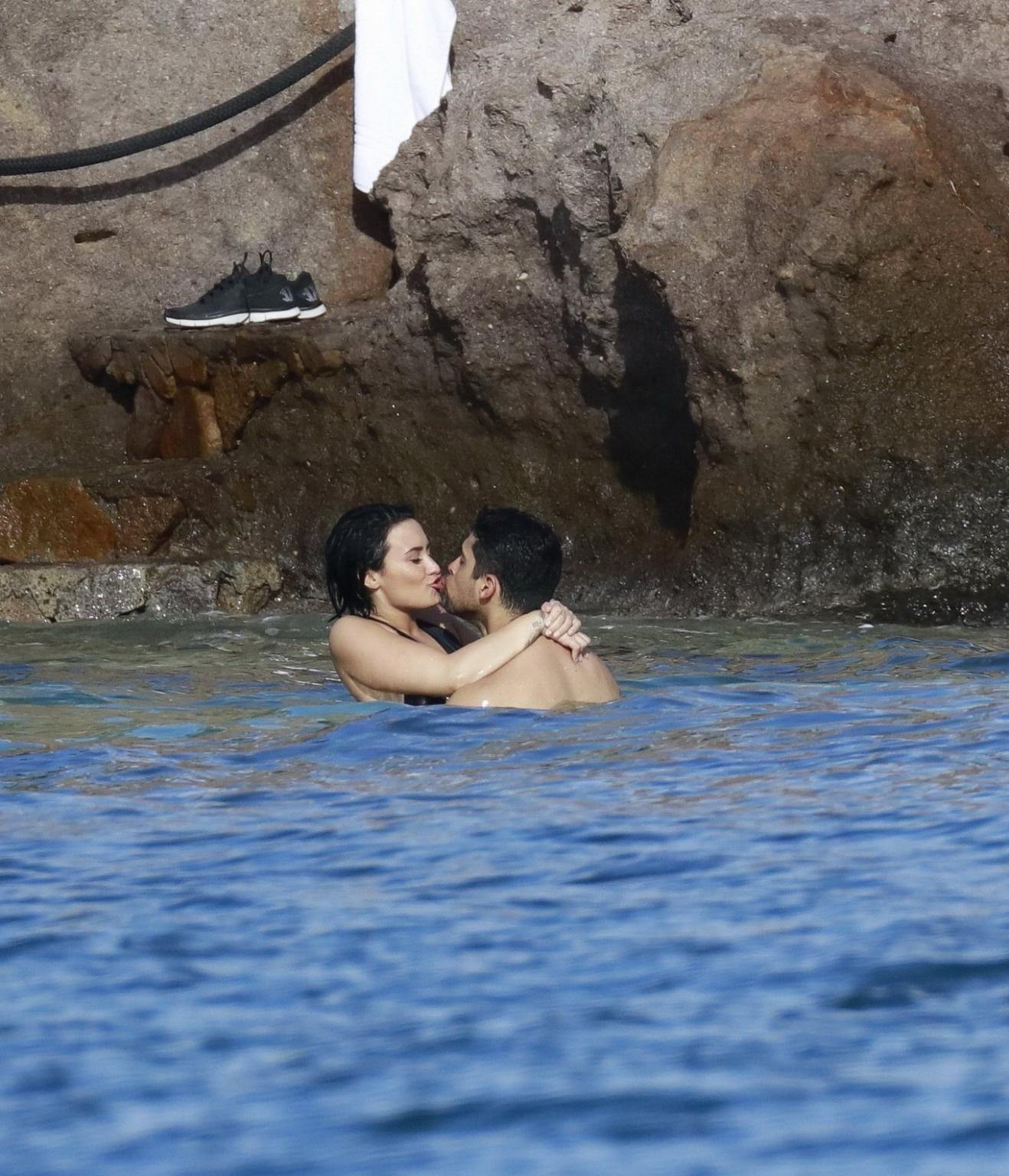 16P Demi Lovato showing her round ass in black swimsuit