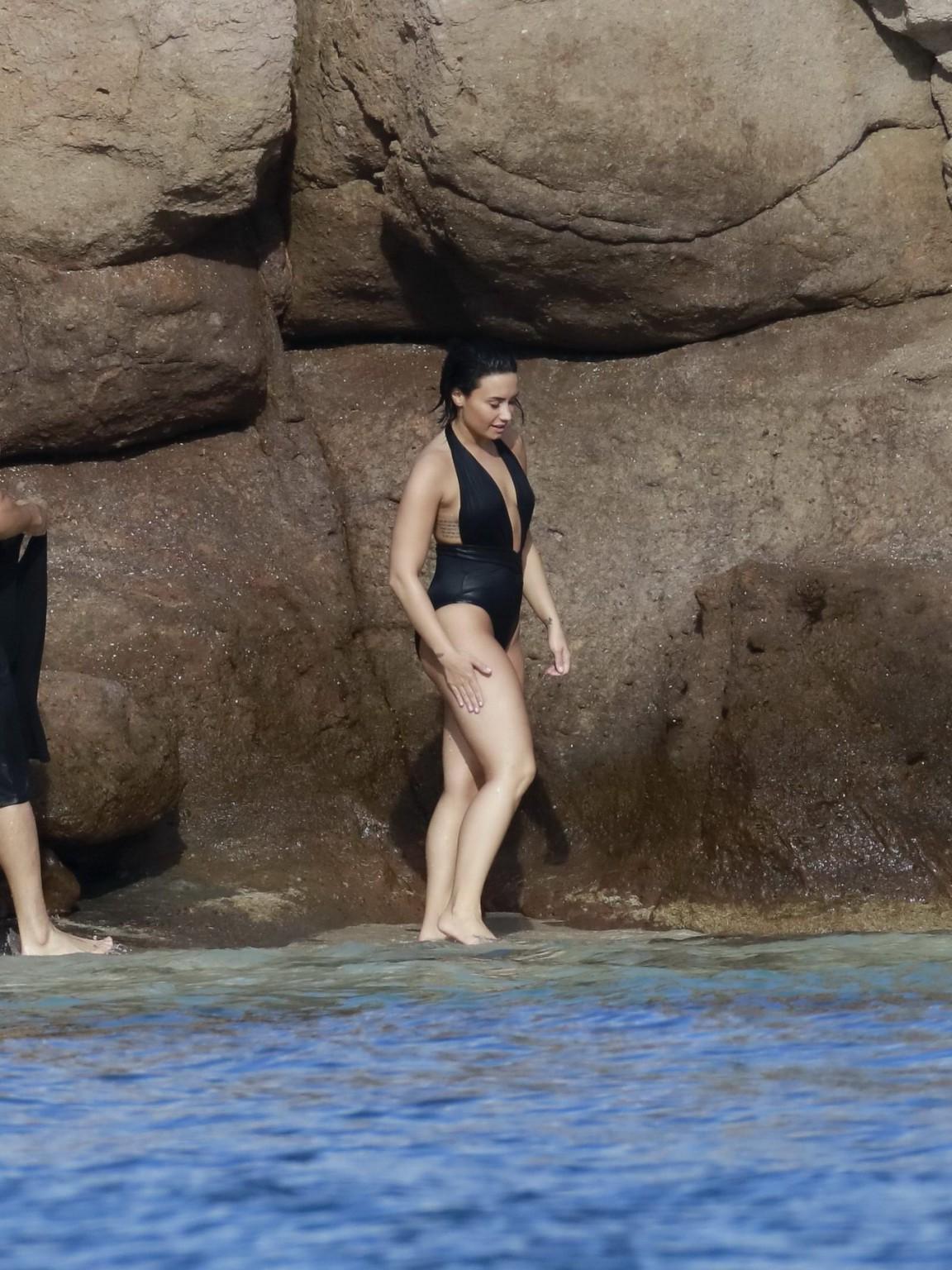 16P Demi Lovato showing her round ass in black swimsuit
