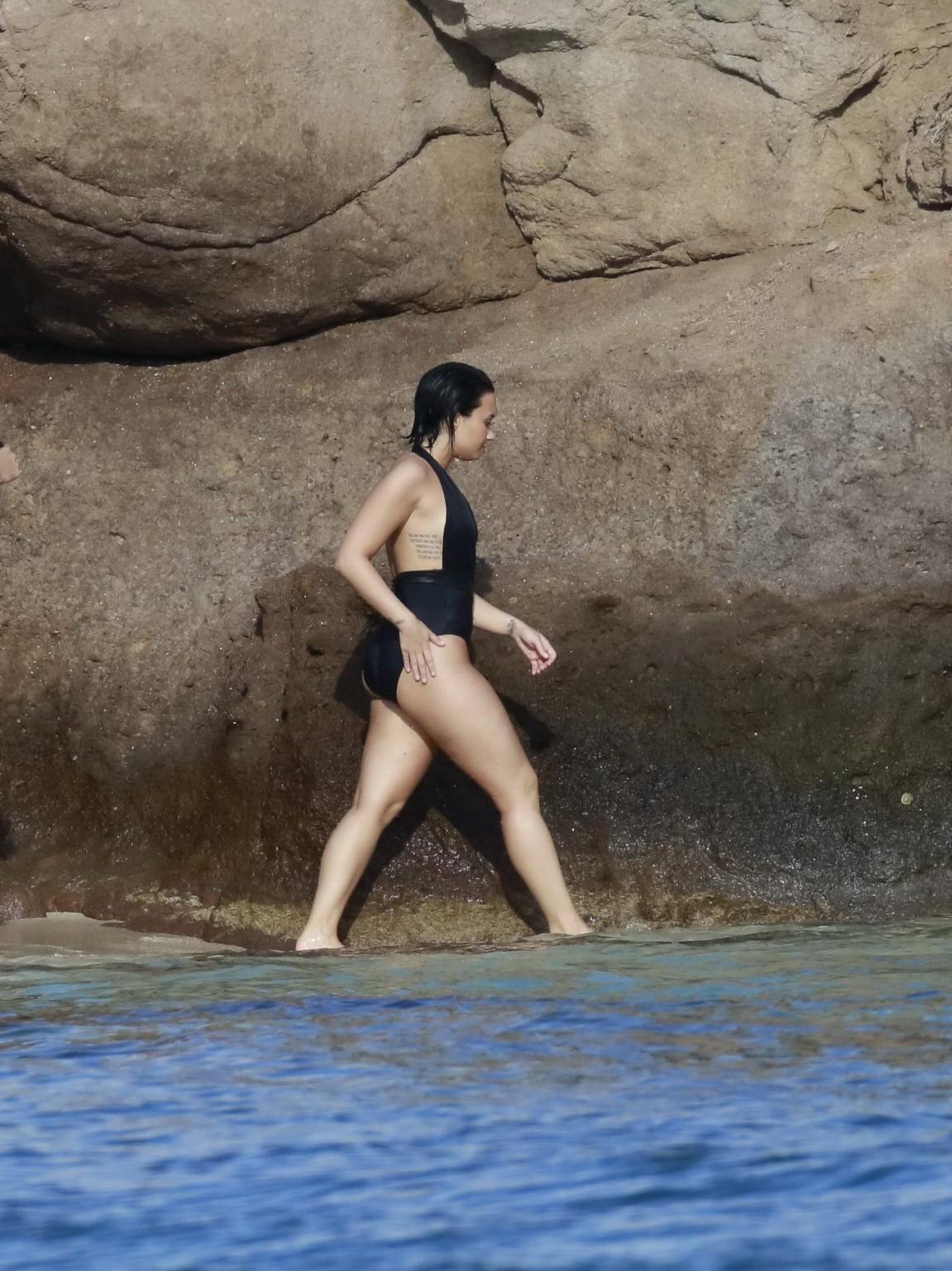 16P Demi Lovato showing her round ass in black swimsuit