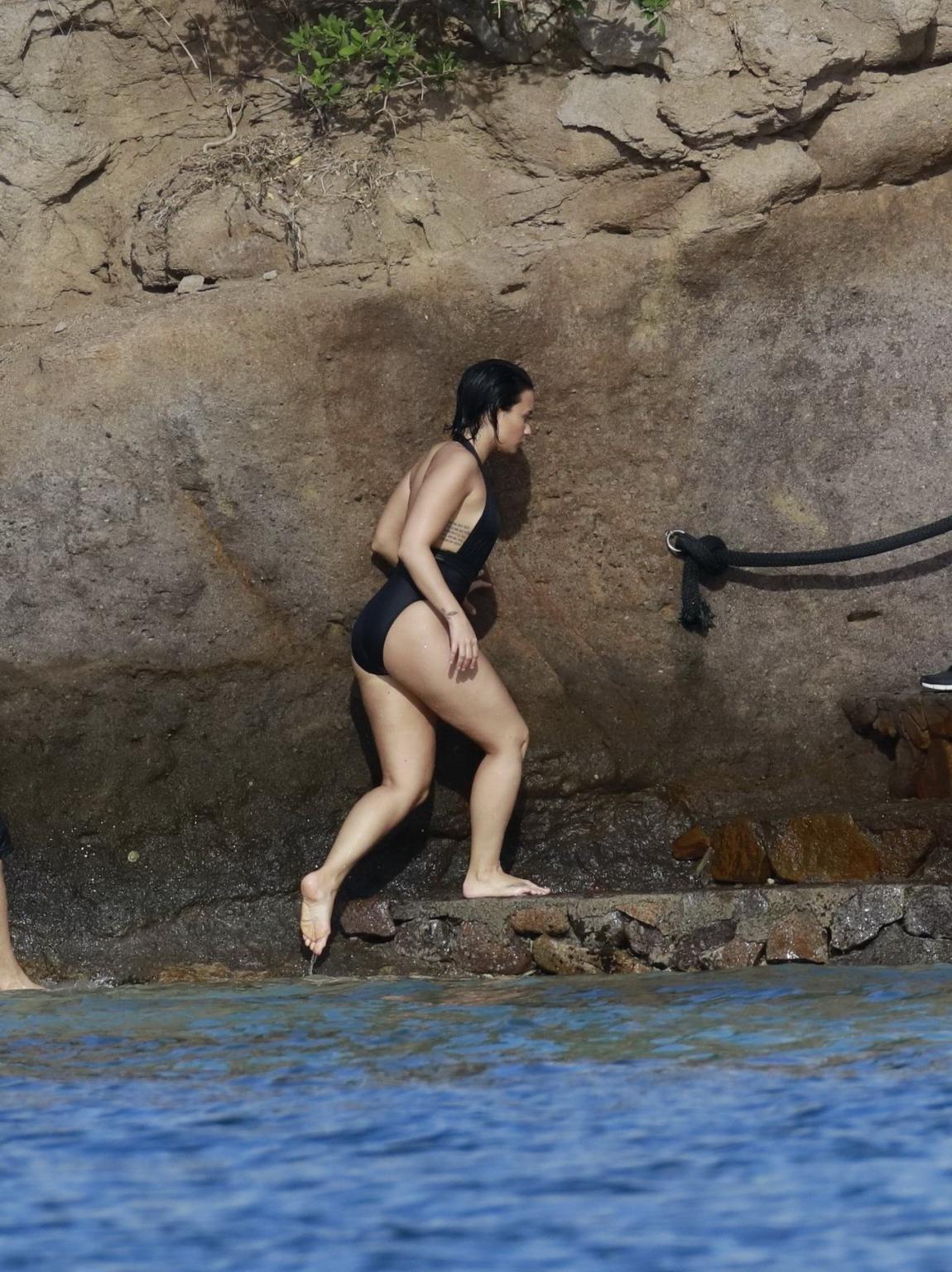 16P Demi Lovato showing her round ass in black swimsuit