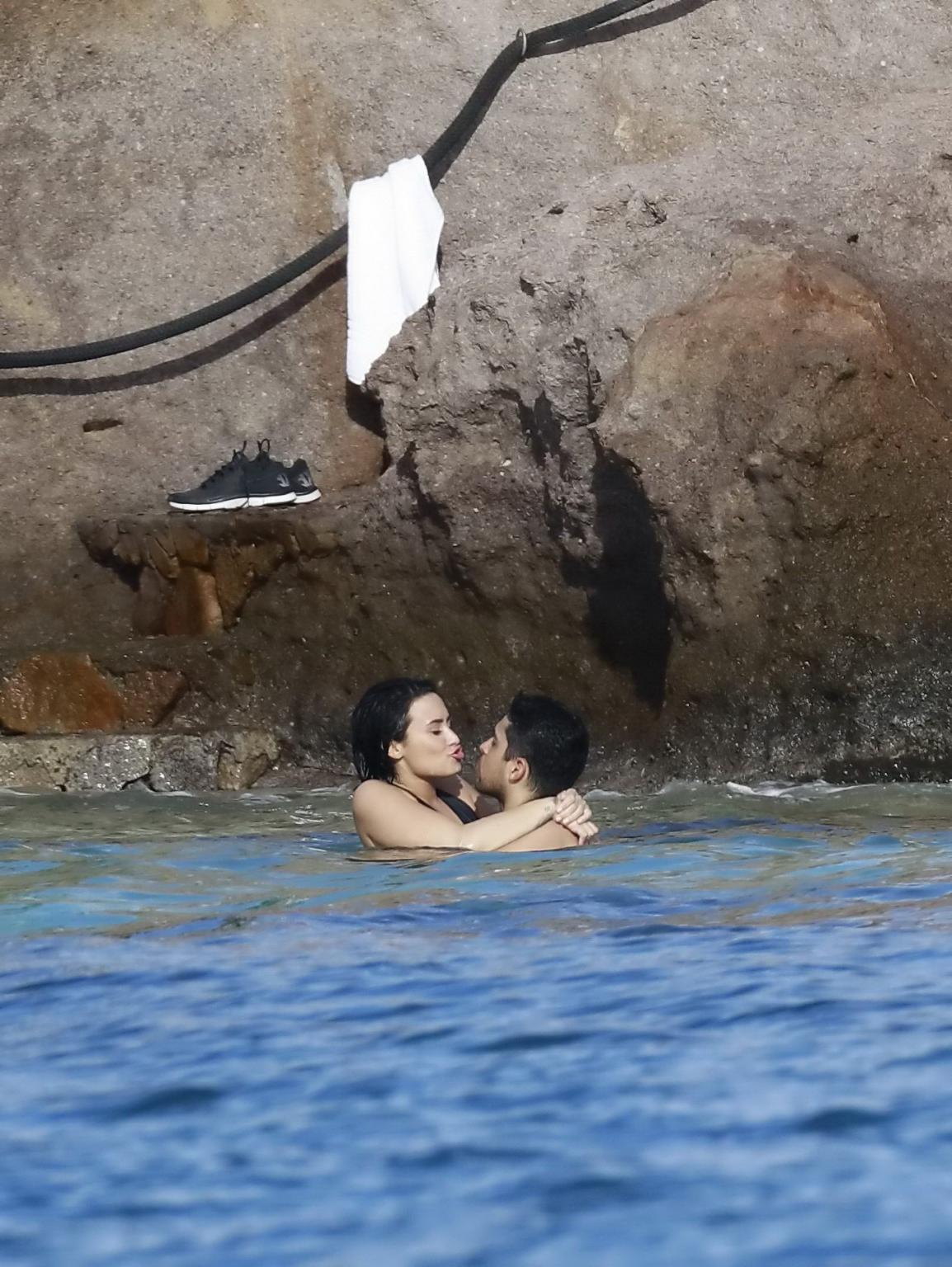 16P Demi Lovato showing her round ass in black swimsuit