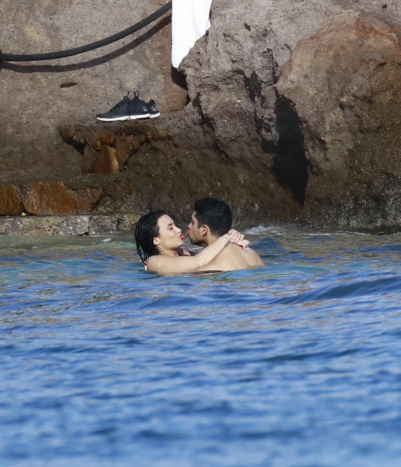 16P Demi Lovato showing her round ass in black swimsuit