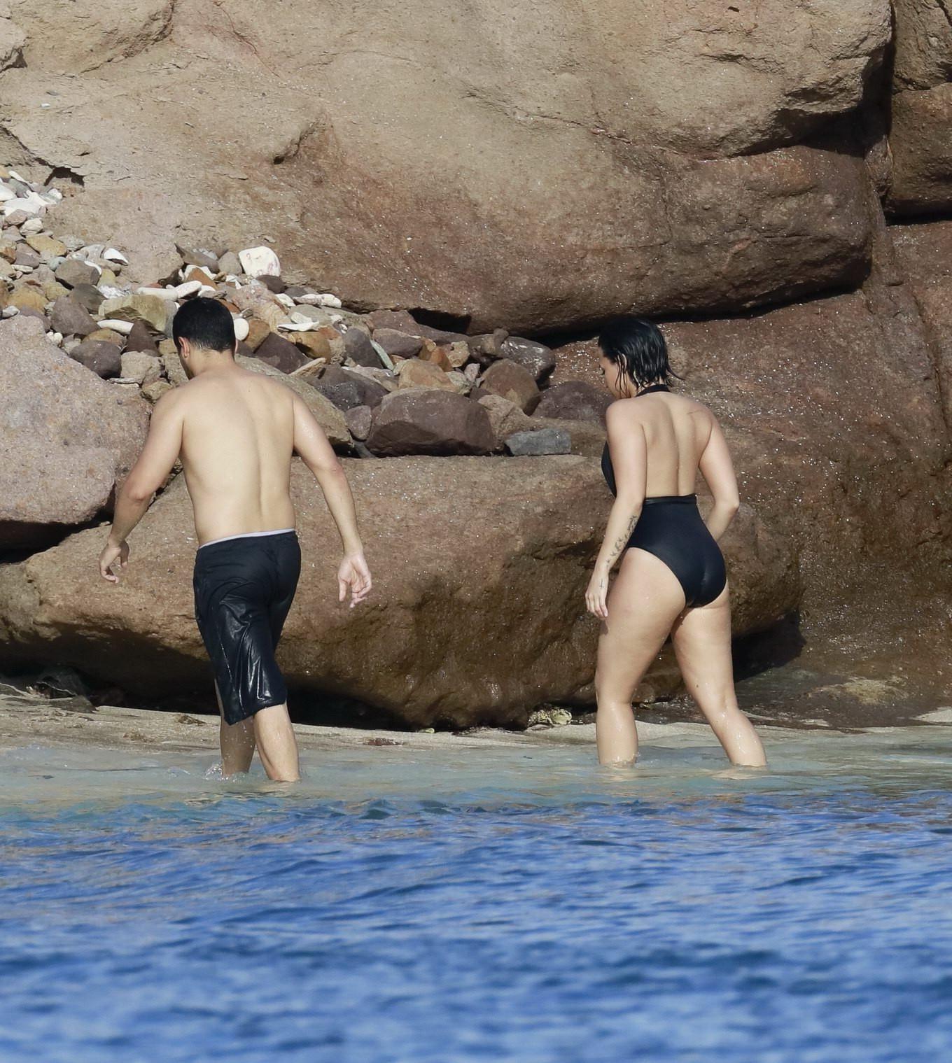 16P Demi Lovato showing her round ass in black swimsuit