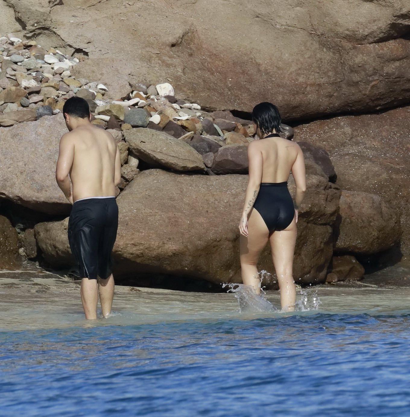 16P Demi Lovato showing her round ass in black swimsuit