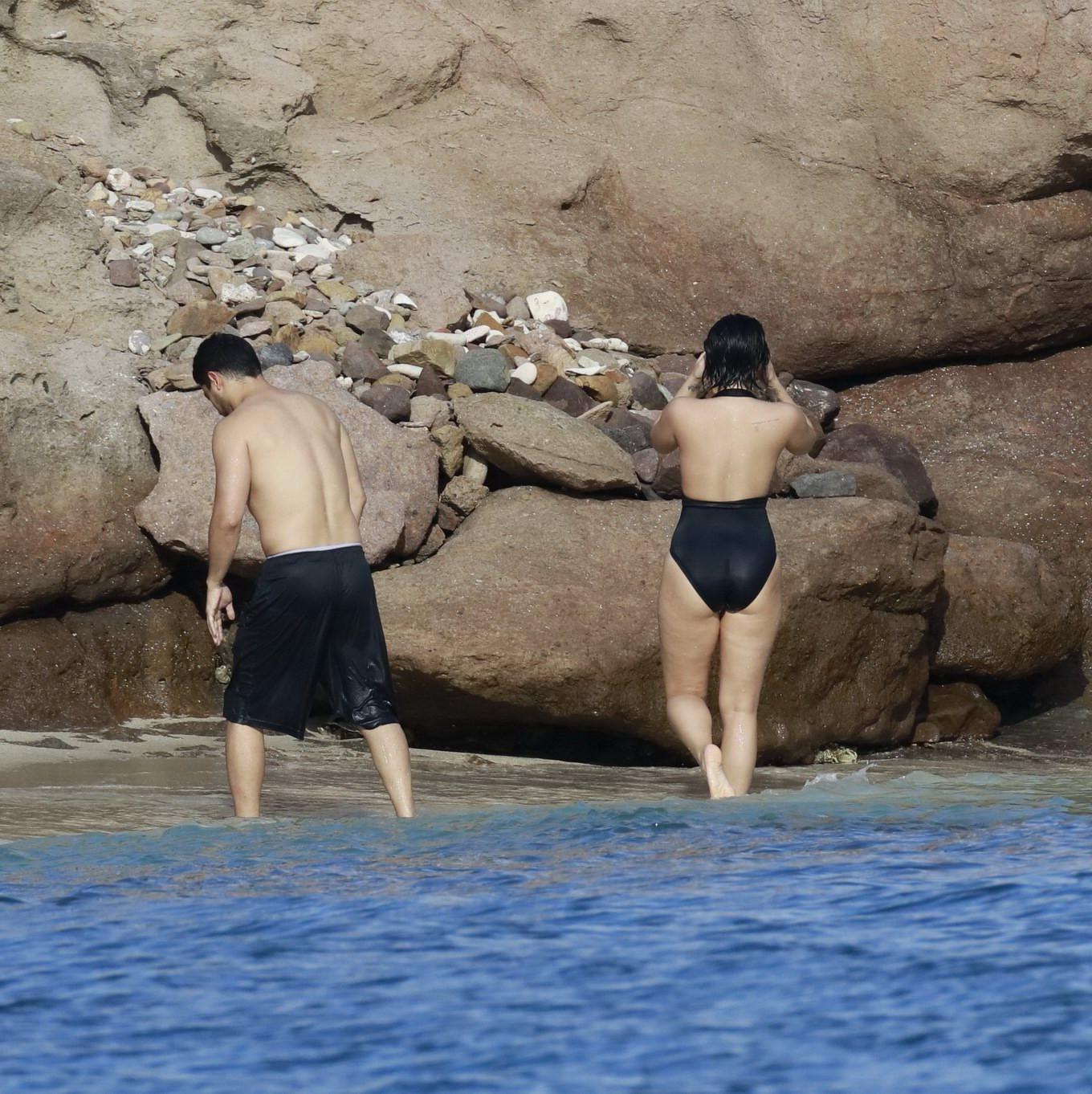 16P Demi Lovato showing her round ass in black swimsuit