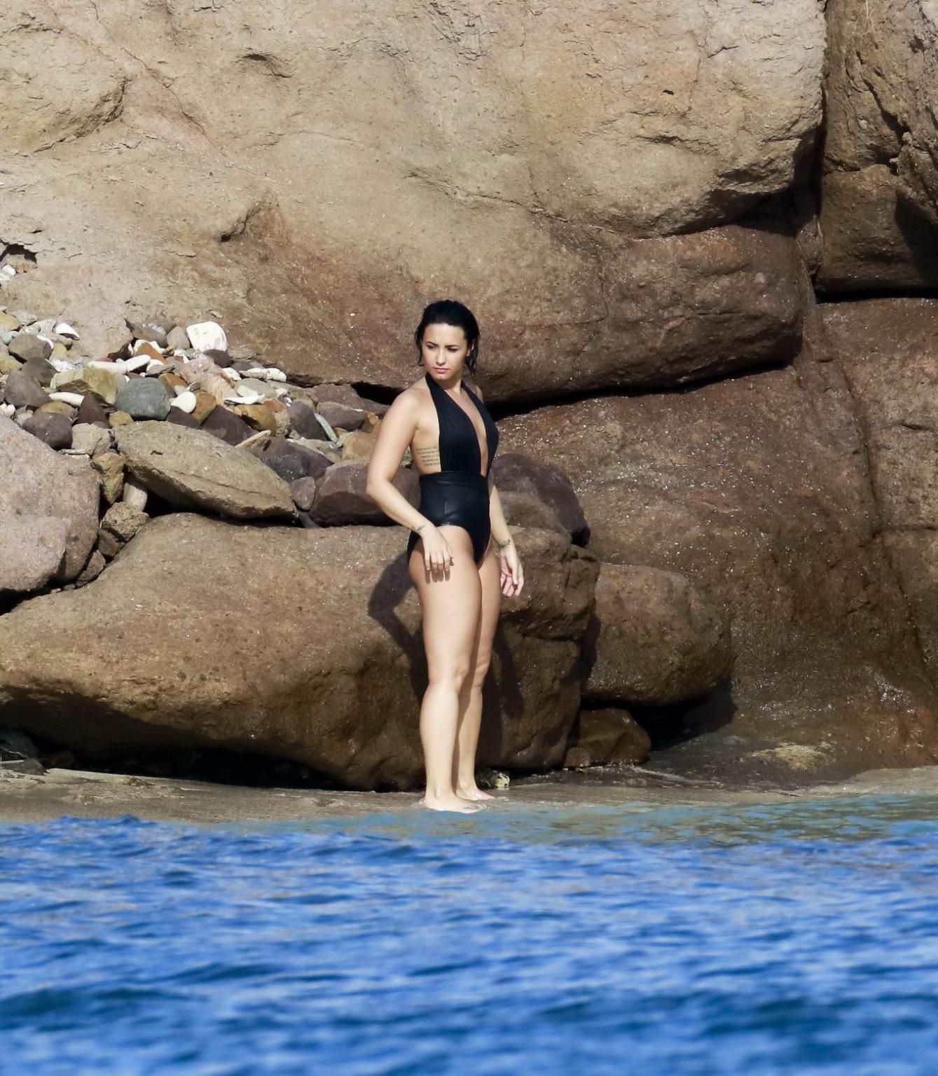 16P Demi Lovato showing her round ass in black swimsuit