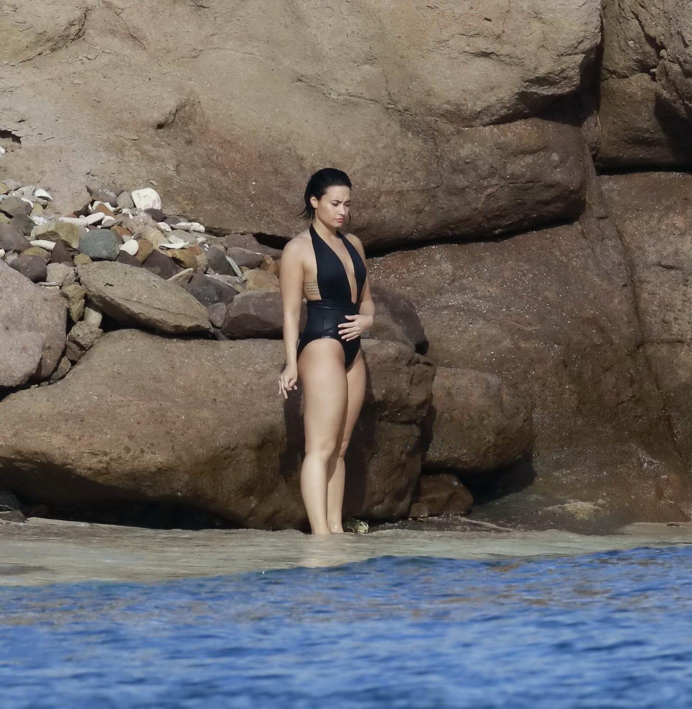 16P Demi Lovato showing her round ass in black swimsuit