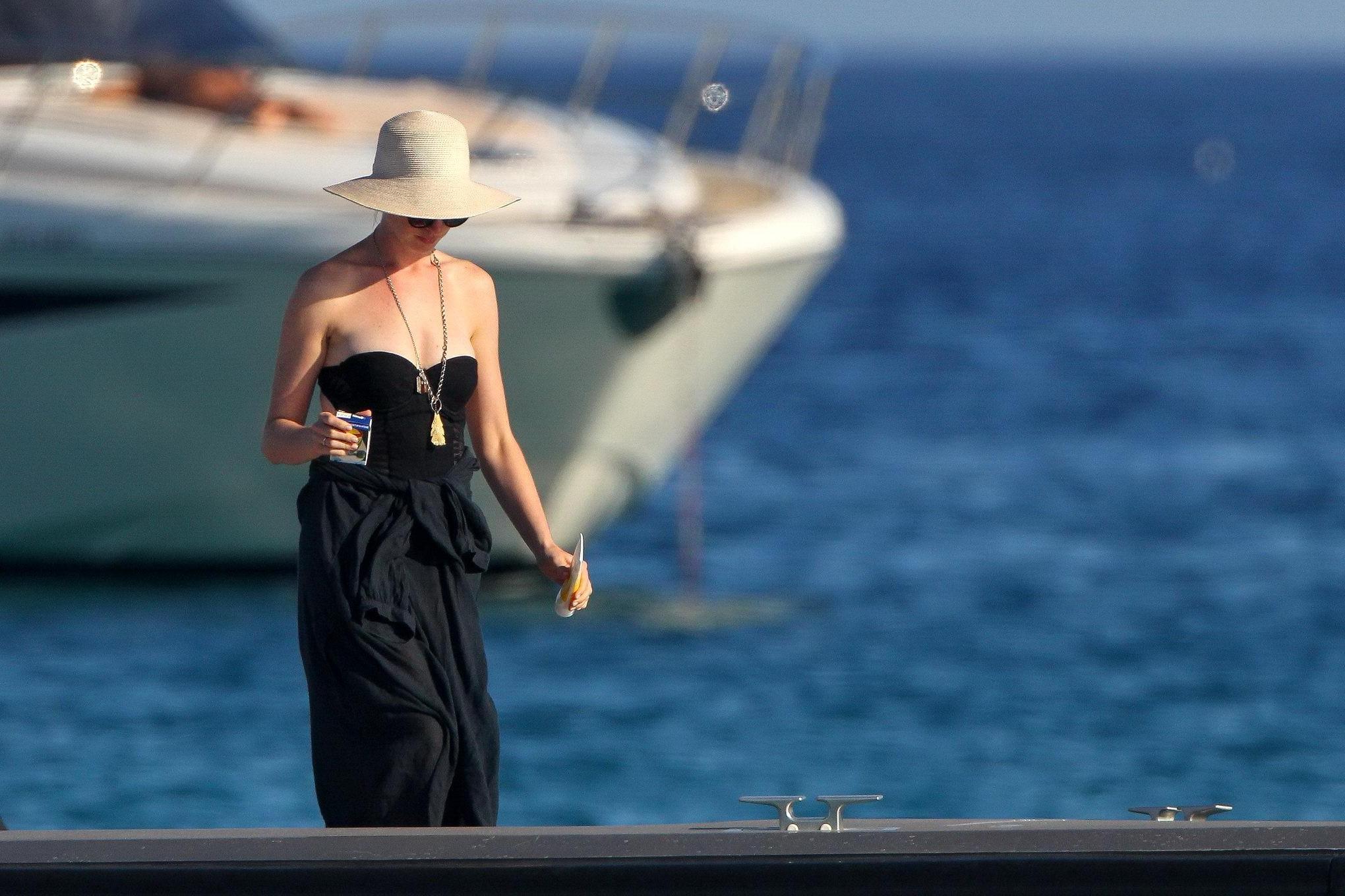 16P Anne Hathaway busty wearing a strapless black swimsuit