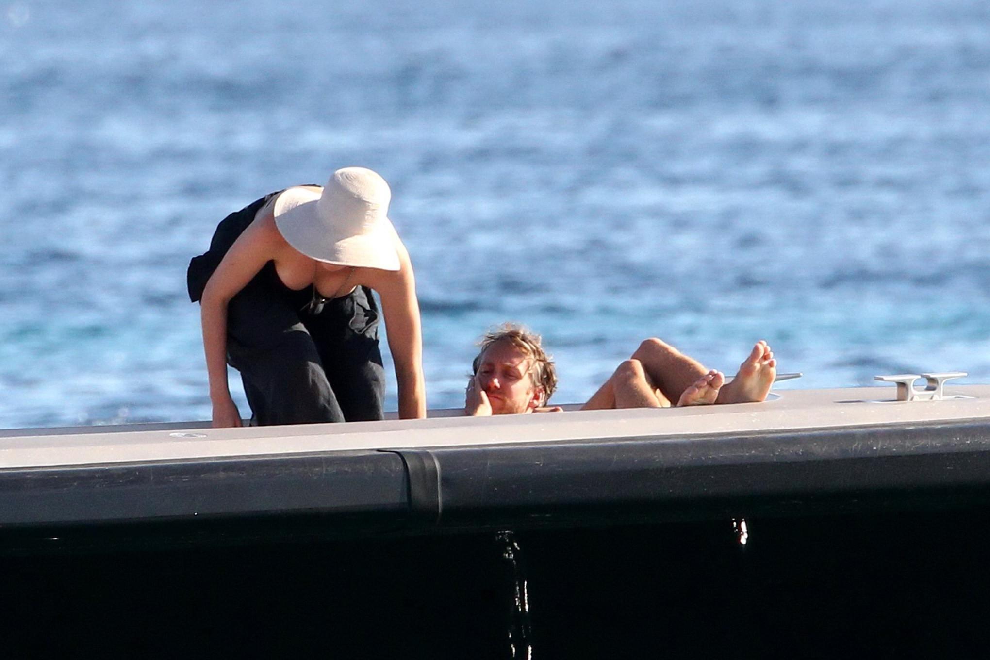 16P Anne Hathaway busty wearing a strapless black swimsuit