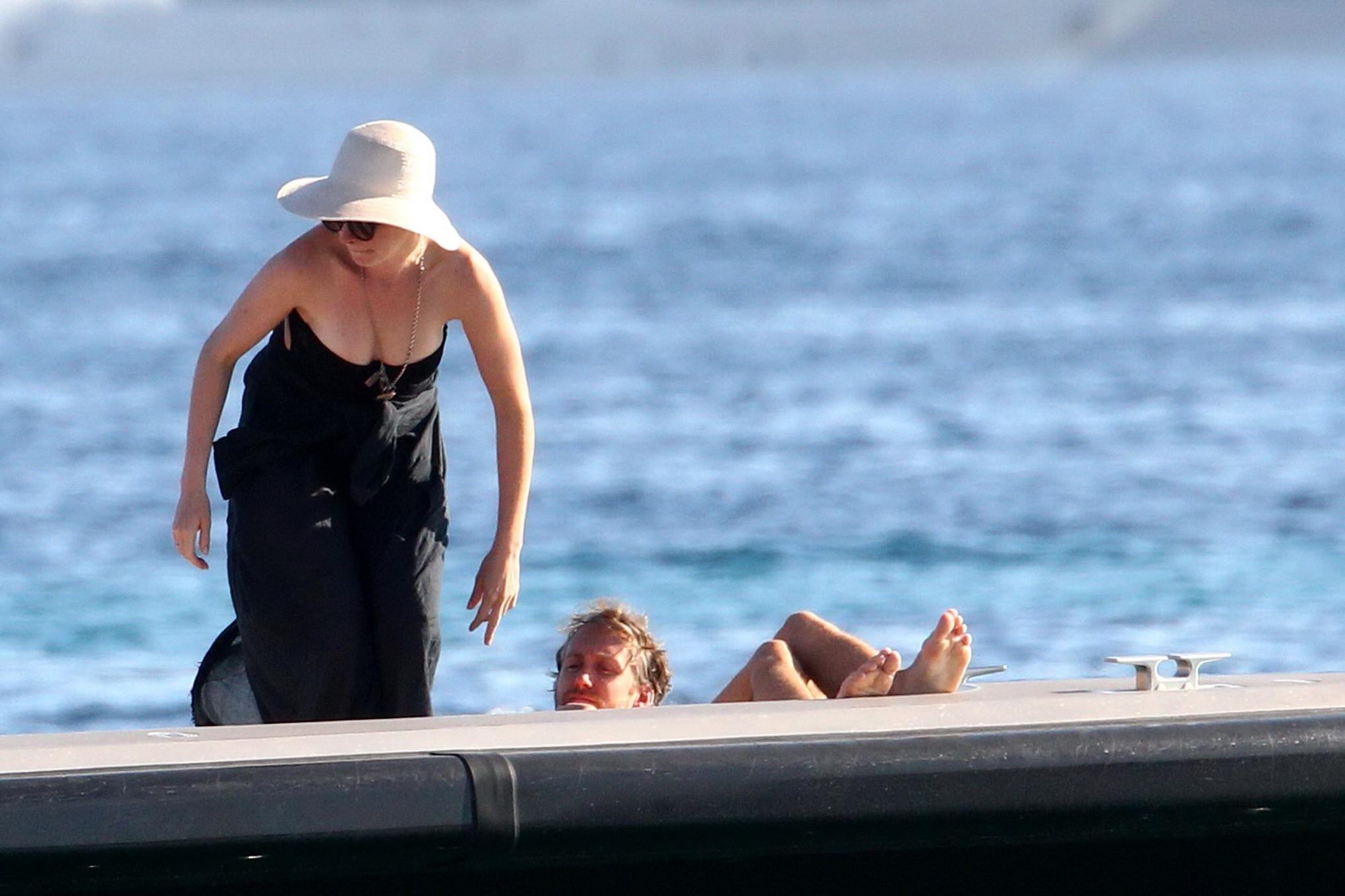 16P Anne Hathaway busty wearing a strapless black swimsuit